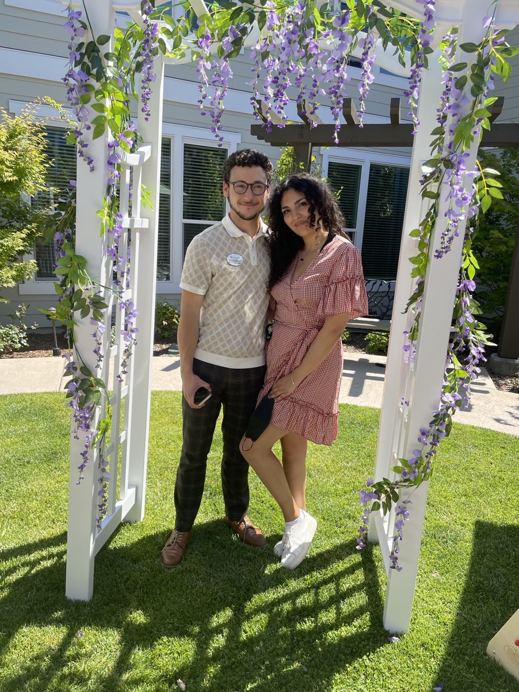 Tristan and Ileana under a flowered arbor