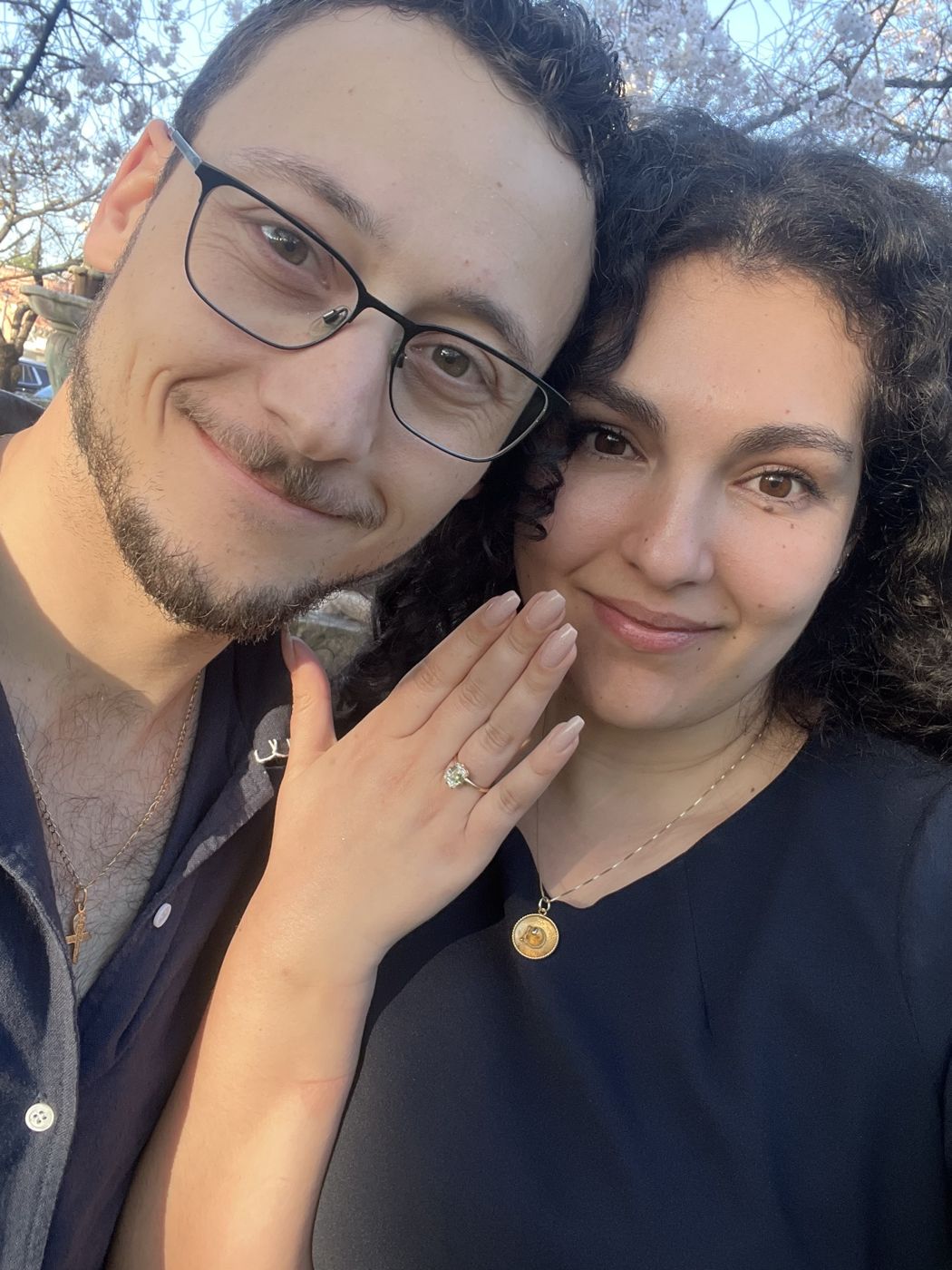 Tristan and Ileana smiling as she shows her engagement ring