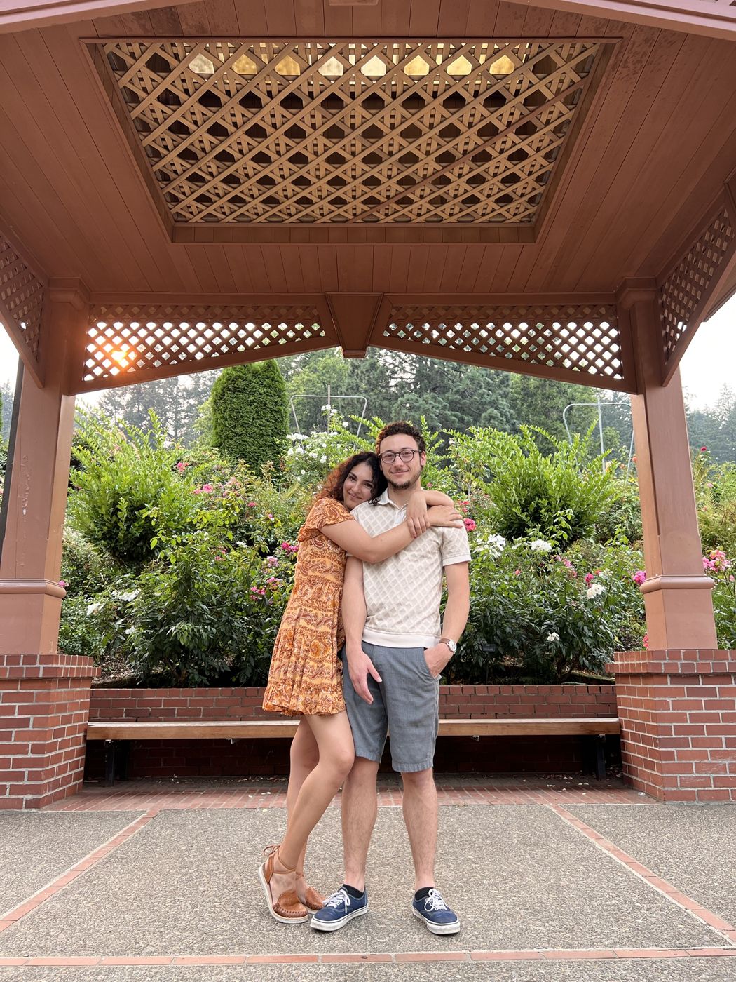 Tristan and Ileana hugging under a gazebo