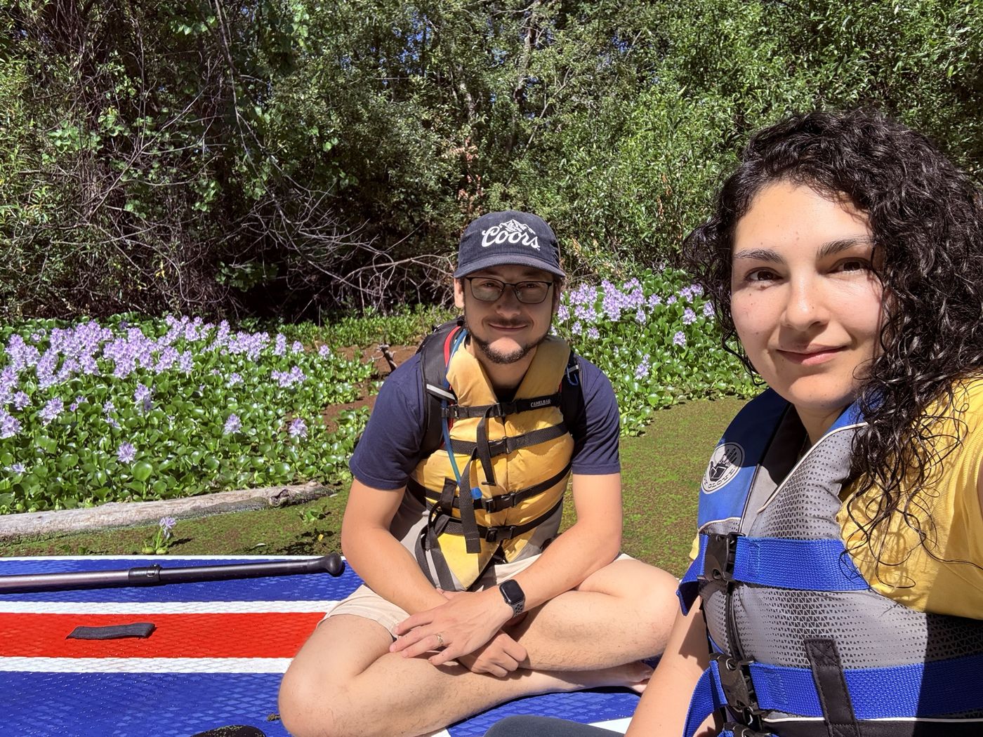 Tristan and Ileana in life jackets on the water